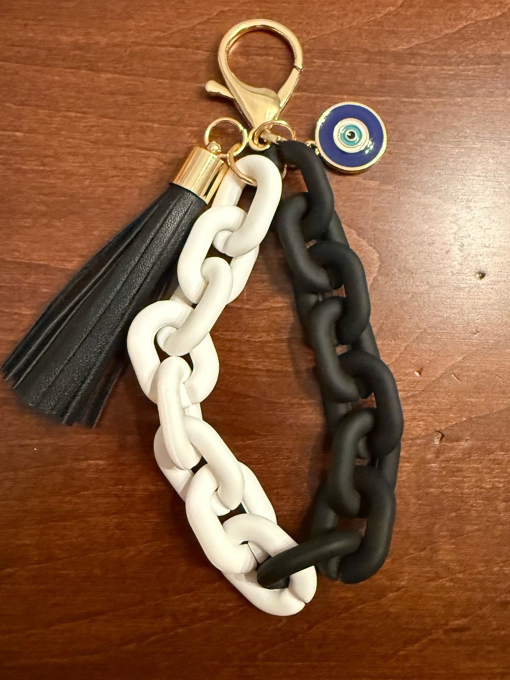 NEW. 🧿 🖤 Bag charm or keychain. Faux leather tassel, removable evil eye charm